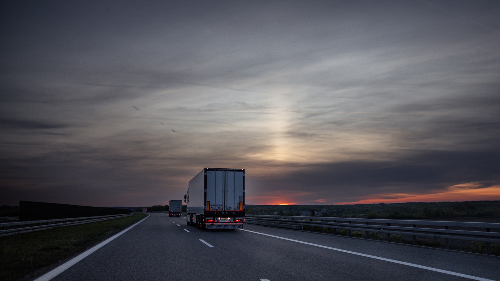 AI-dispatched fleet truck on highway at dusk